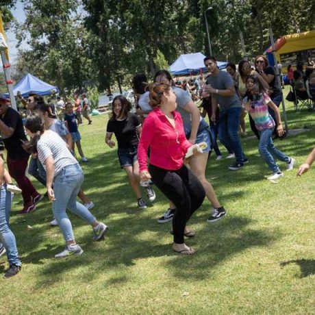 people dancing and smiling in grassy area