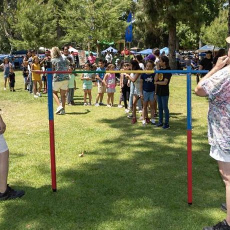 kids lined up for limbo contest in front of judges