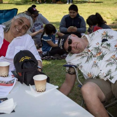 people smiling for photo and bending sideways in folding chairs