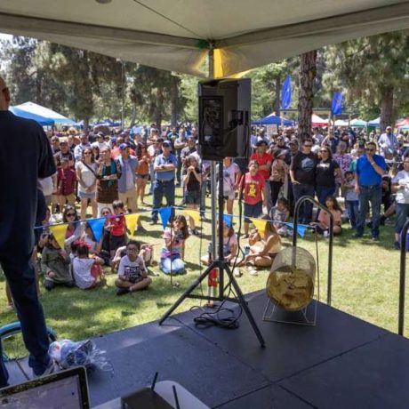 man speaking to crowd from stage