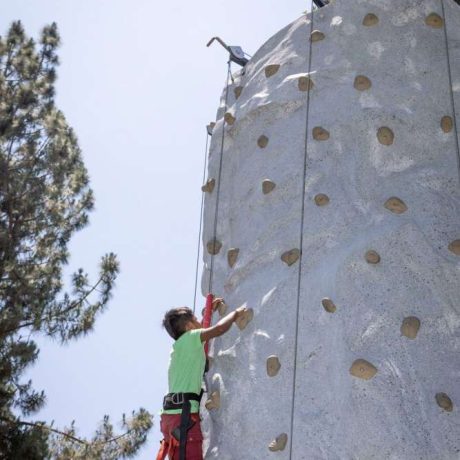 kid rock climbing on climbing wall