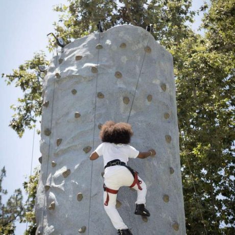 person climbing rock-climbing wall