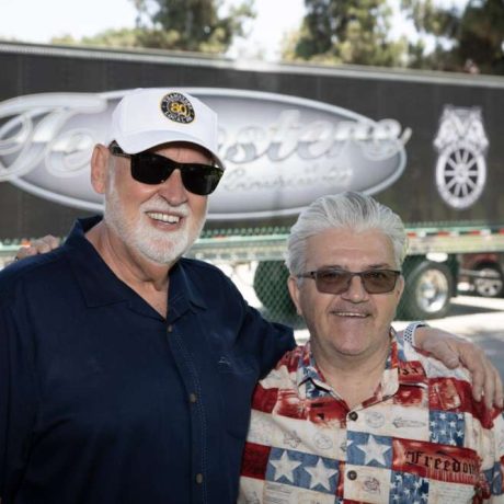 men smiling together in front of teamsters truck