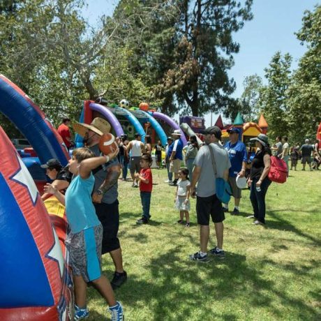 people playing various games at picnic in park