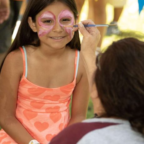 child smiling getting her face painted