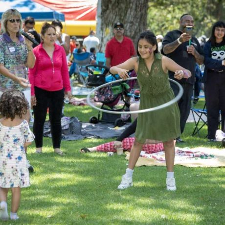 kid playing with hula hoop