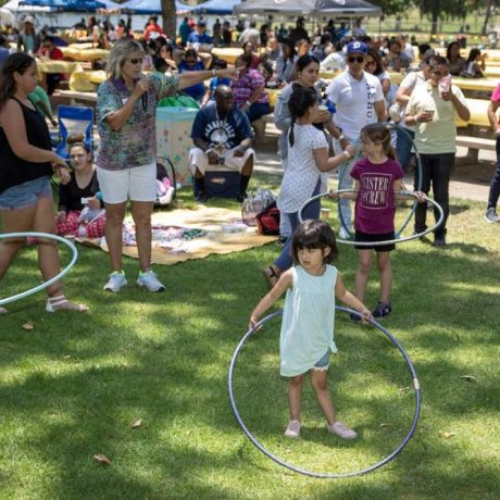 kids playing with hula hoops at park