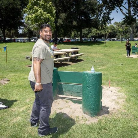 man smiling playing horseshoes