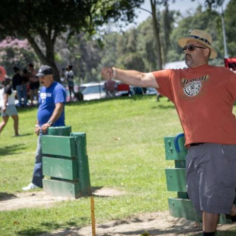 man throwing horseshoe