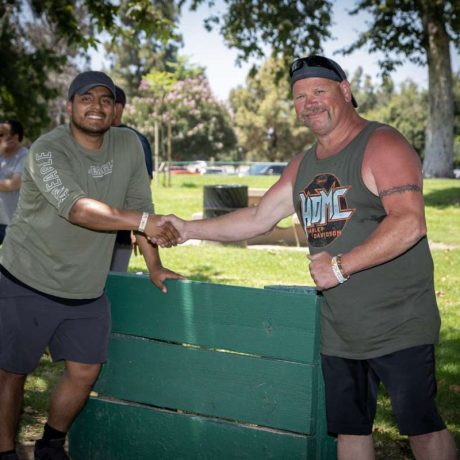 people shaking hands after horseshoe game