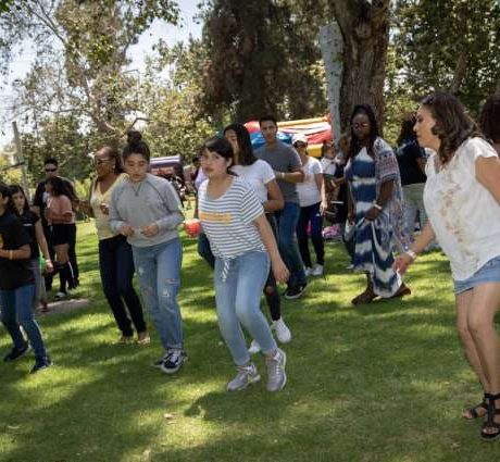 people dancing together at park