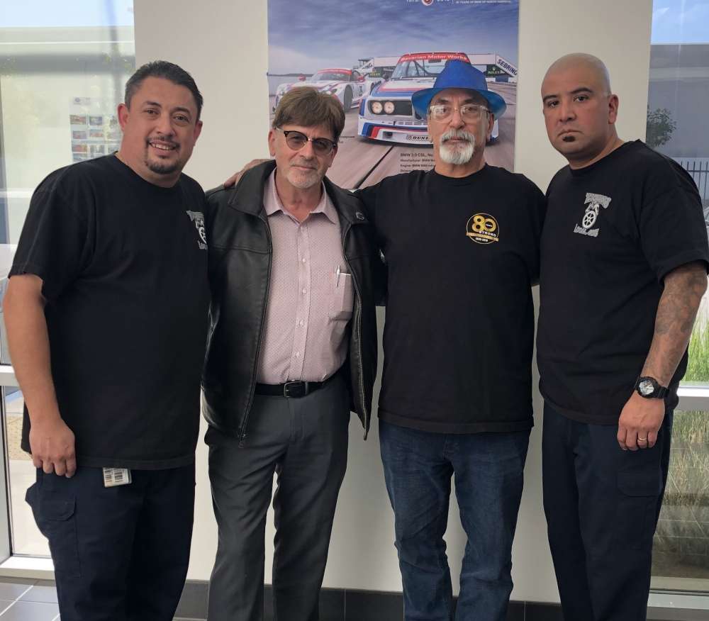 men standing together, Tito Zaras wearing blue hat