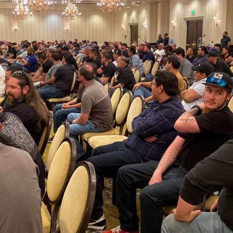 large group of people sitting together in presentation room