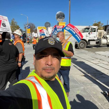 man taking selfie with teamster rally behind him