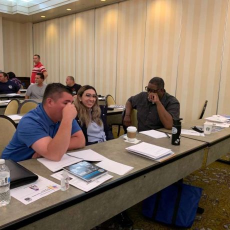 people laughing together at seminar