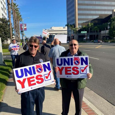people holding signs that read "union yes"