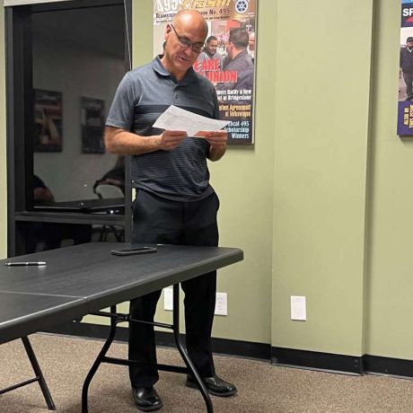 man reading from paper slip