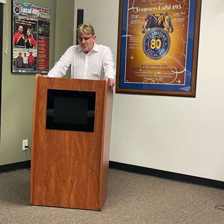 man giving speech at podium