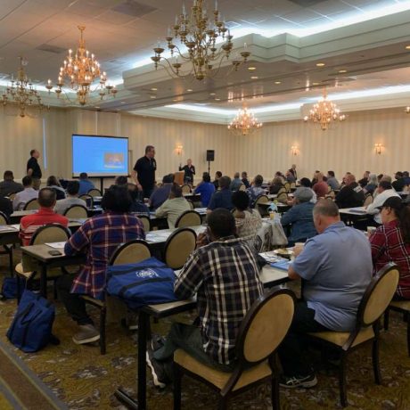 people sitting together in large room for seminar