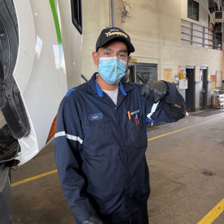 man giving thumbs up while working in garage