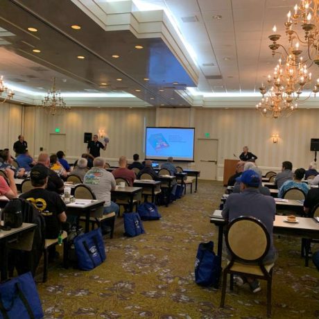 people seated together in large room for seminar