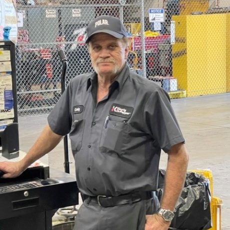 man standing smiling in work clothing