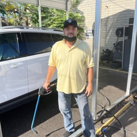 man standing in front of car