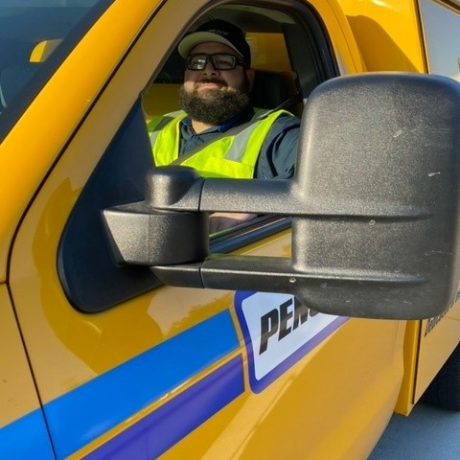 man in truck working and smiling