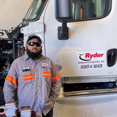 man standing in front of truck in uniform