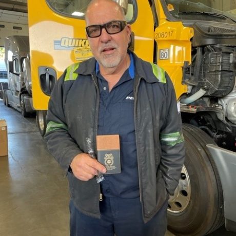 man posing for photo in front of truck