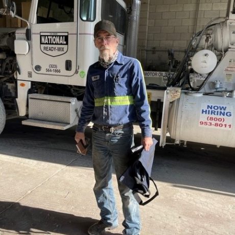 man standing in garage in work clothing