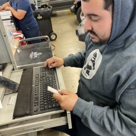 man sitting at computer checking item