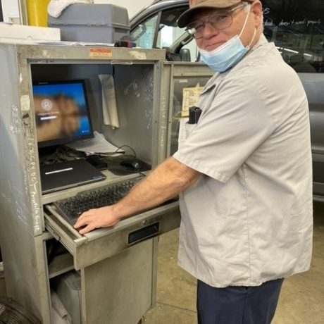 man smiling working on computer