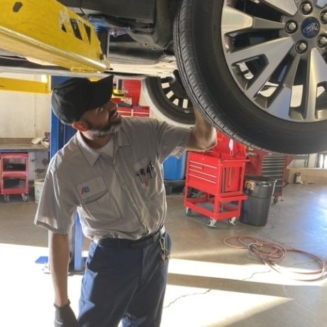 man working on car in uniform