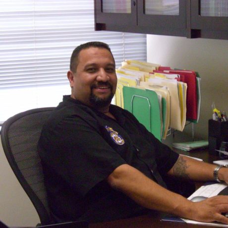 gene rivera smiling at desk