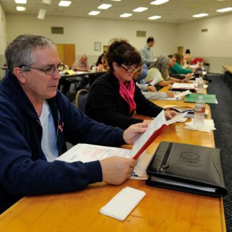 room of people reviewing paperwork