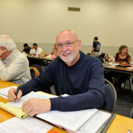 man smiling and writing