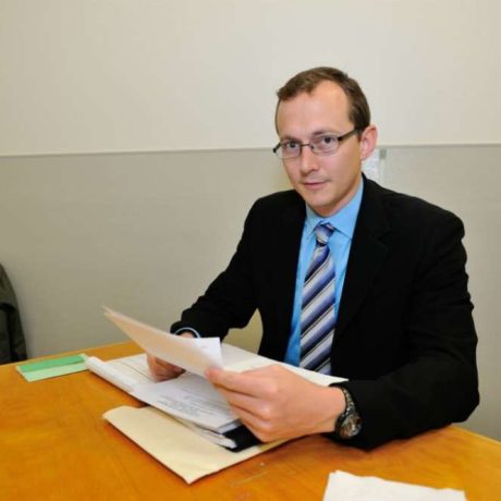 man in suit reviewing documents