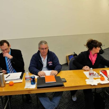 people seated with papers and folders