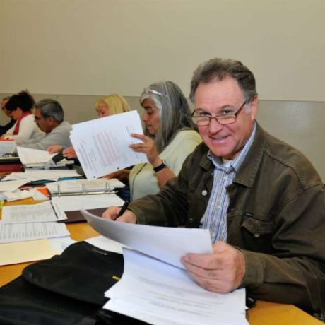 man smiling while reviewing documents