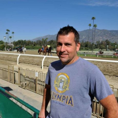 man standing at racetrack