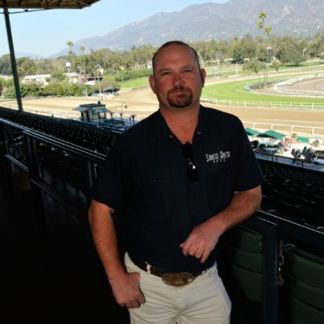 man standing in front of racetrack