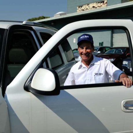 man smiling getting into truck