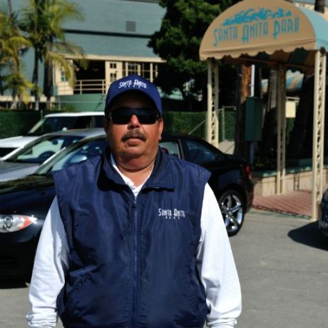 man standing next to entrance of park