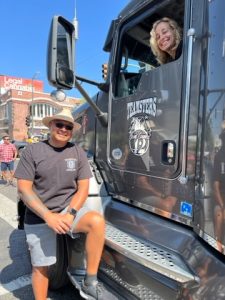 people smiling with a teamsters logo truck