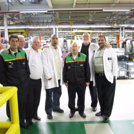 people together smiling for photo in industrial setting