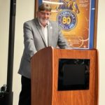 man speaking at podium