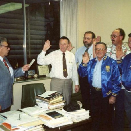 group of people taking oath with right hands held up