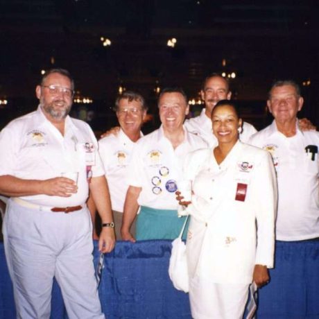 group of people smiling together in uniforms