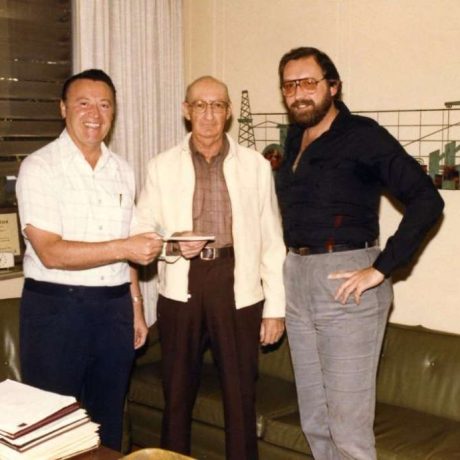 karl ullman smiling standing with two other men posing for photo